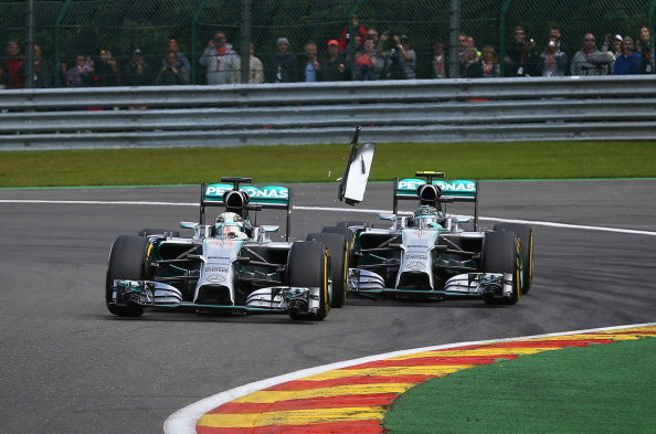 SPA, BELGIUM - AUGUST 24:  Debris flies in the air as Nico Rosberg of Germany and Mercedes GP makes contact with Lewis Hamilton of Great Britain and Mercedes GP during the Belgian Grand Prix at Circuit de Spa-Francorchamps on August 24, 2014 in Spa, Belgium.  (Photo by Clive Mason/Getty Images)